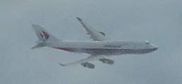 Malaysia Boeing 747-400 on Final Approach at London LHR Jan 04 - this photo was taken from a Singapore 747 in the stack just above it, as the Malaysian beared right to enter its final approach